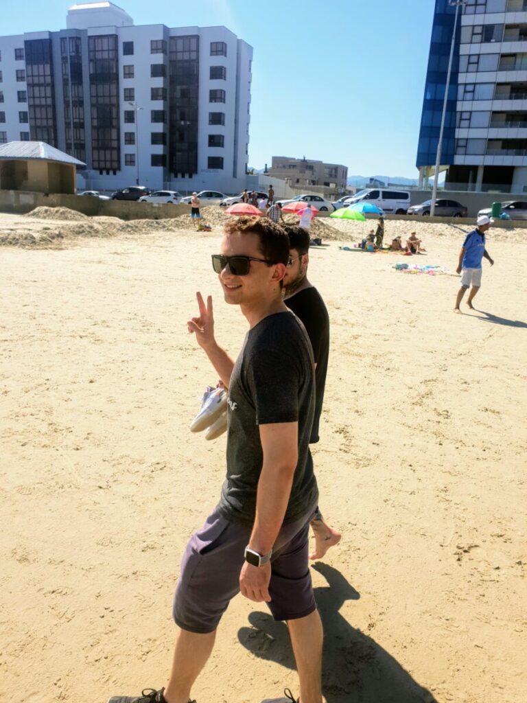 Lincoln, a client of Marcia Swanepoel, enjoying a rejuvenating walk along Strand Beach near Somerset West, boosting heart health and cardiovascular fitness in a scenic outdoor setting.