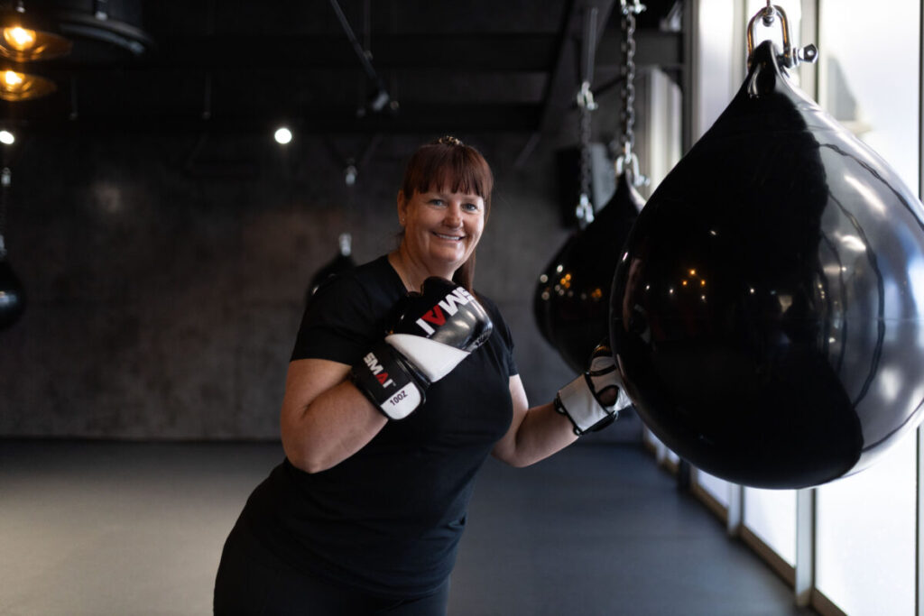 Marcia Swanepoel demonstrating proper form while striking a heavy punching bag at Virgin Active The Sanctuary in Somerset West, showcasing boxing as an effective and dynamic cardio workout to enhance heart health.